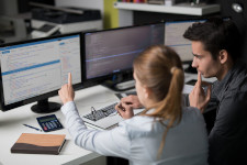 Woman pointing at computer screen with web design